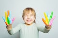 Happy laughing girl art school student showing her colorful painted hands on white background Royalty Free Stock Photo