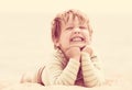 Happy laughing girl laying on sand beach Royalty Free Stock Photo