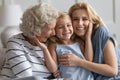 Happy laughing grandmother, mother and little girl embracing Royalty Free Stock Photo