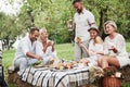 Happy laughing. Group of adult friends have a rest and conversation in the backyard of restaurant at dinner time Royalty Free Stock Photo