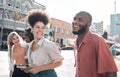 Happy, laughing group of friends walking and smiling together in a city. Casual excited people enjoying a relaxing time Royalty Free Stock Photo