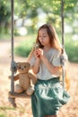 Happy laughing kid girl with long hair enjoying a swing ride on a sunny summer day Royalty Free Stock Photo