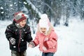 Happy laughing kids in a beautiful snowy winter forest Royalty Free Stock Photo