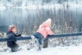 Happy laughing kids in a beautiful snowy winter forest Royalty Free Stock Photo