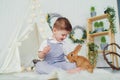 Happy laughing little boy playing with a baby rabbit, hugging real bunny pet and learning to take care of an animal Royalty Free Stock Photo