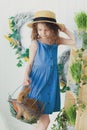 Happy laughing little girl playing with a baby rabbit, hugging her real bunny pet and learning to take care of an animal Royalty Free Stock Photo