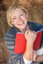 Happy Laughing Middle Aged Woman Reading a Book or Diary