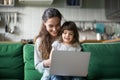 Happy laughing mother and daughter using laptop Royalty Free Stock Photo