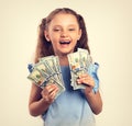 Happy laughing rich kid girl holding money in the hand. Vintage Royalty Free Stock Photo