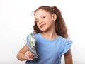 Happy laughing rich kid girl holding money hand on white background with empty copy space Royalty Free Stock Photo