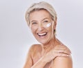 Happy, laughing and sunscreen on skin care beauty model on studio background. Portrait of mature woman, face and smile Royalty Free Stock Photo