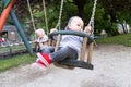 Cute Baby Twins Having Fun on a Swing Royalty Free Stock Photo