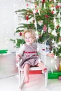 Happy laughing toddler girl with Christmas lights Royalty Free Stock Photo