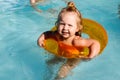 Happy laughing toddler girl having fun in a swimming pool Royalty Free Stock Photo