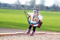 Happy laughing toddler girl swinging on playground Royalty Free Stock Photo