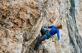 happy laughing woman climber having fun and climbing on rock, hanging on rope Royalty Free Stock Photo