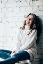 Happy laughing woman relaxing on brick wall background Royalty Free Stock Photo