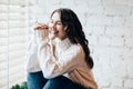 Happy laughing woman relaxing on window sill Royalty Free Stock Photo