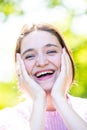 A happy laughing young woman with perfect skin, natural make-up and a beautiful smile. Lifestyle concept showing Royalty Free Stock Photo