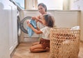 Happy, laundry and washing machine with mother and daughter for helping, learning and cleaner. Housekeeping, teamwork Royalty Free Stock Photo