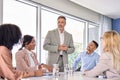 Happy leader and company employees at business meeting discussing work plan. Royalty Free Stock Photo