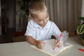 Left-handed boy put his left hand in plastic glove to avoid messy, international left-hander day