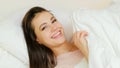 Happy leisure flirty smiling girl laying bed