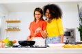Happy lesbian couple cooking in kitchen at home, Women preparing dinner on first dating, Couple of female lovers Royalty Free Stock Photo