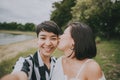 Happy lesbian couple having fun kissing and taking a selfie Royalty Free Stock Photo