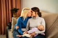 Happy lesbian couple having tender moments with their small baby at home Royalty Free Stock Photo