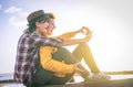 Happy lesbian couple taking a selfie with mobile smart phone camera on the beach at sunset - Vignette edit Royalty Free Stock Photo