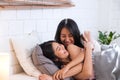 Happy lesbian couple wake up on bed in bedroom in morning and hug each other at home.LGBTQ lifestyle concept Royalty Free Stock Photo