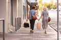 Happy lesbian couple walking in the city carrying shopping bags Royalty Free Stock Photo