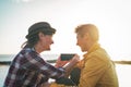 Happy lesbian couple watching on mobile phone next the beach at sunset - Young homosexual women having fun Royalty Free Stock Photo