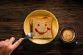 Happy Life concept. Young Person Eating Bread and Coffee Cup in Breakfast Time. Smiling Face Drawn on Bread