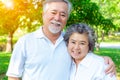 Happy life and long lived concept. Handsome old man and beautiful old woman embracing together, look at camera. Older couple have