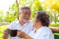 Happy life and long lived concept. Older couple is clinking cup of coffee and enjoying the drink in the morning. Handsome Royalty Free Stock Photo