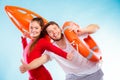 Happy lifeguard couple with equipment