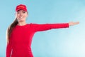 Happy lifeguard woman in cap pointing direction. Royalty Free Stock Photo