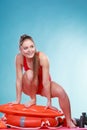 Happy lifeguard woman on rescue ring buoy.