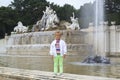 happy liitle girl posing by the Neptune fountain in the garden o