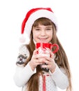 Happy litle girl enjoying big mug of hot drink. isolated on white