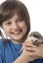 Happy litle girl with her pet African pygmy hedgehog Royalty Free Stock Photo