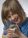 Happy litle girl with her pet African pygmy hedgehog Royalty Free Stock Photo