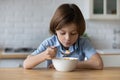 Happy little adorable child boy eating fast dry breakfast.