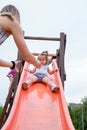 Little adorable girl on slide at children playground Royalty Free Stock Photo