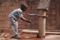 Happy Little African Boy Washing His Hands At the Village Pump