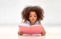 Happy little african girl reading book Royalty Free Stock Photo