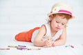 Happy little artist girl in a hat draws pencil Royalty Free Stock Photo