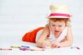 Happy little artist girl in a hat draws pencil Royalty Free Stock Photo